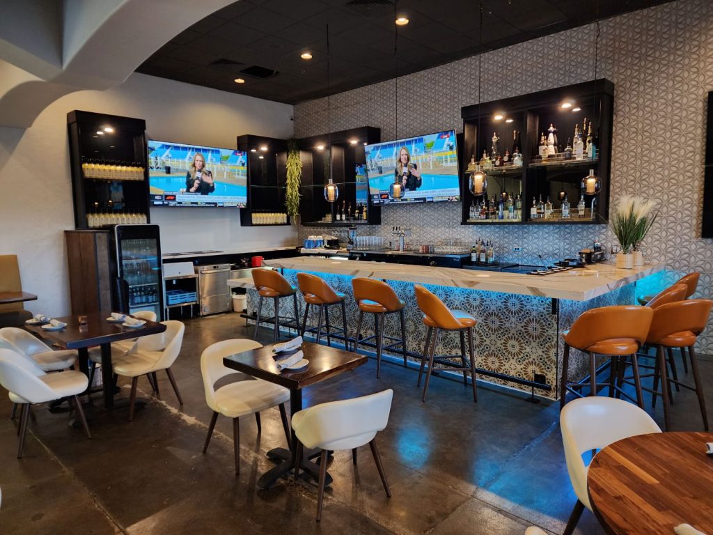 Completed bar area at Sol Agave, designed with decorative tiles, modern lighting, and sleek seating.