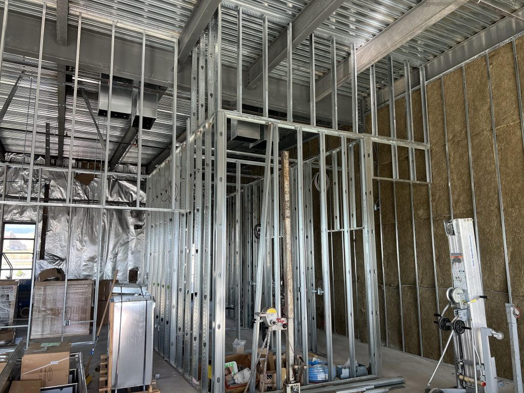 Framing stage of construction by Black Diamond Builders at Don Joaquin Street Tacos, showing steel studs and open wall frames.