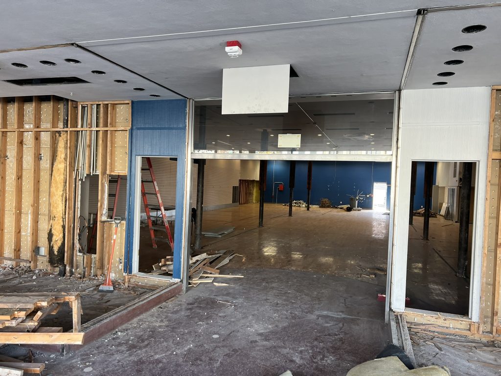 Empty floor space at The Find Lab during renovation, with exposed framework and tools visible.