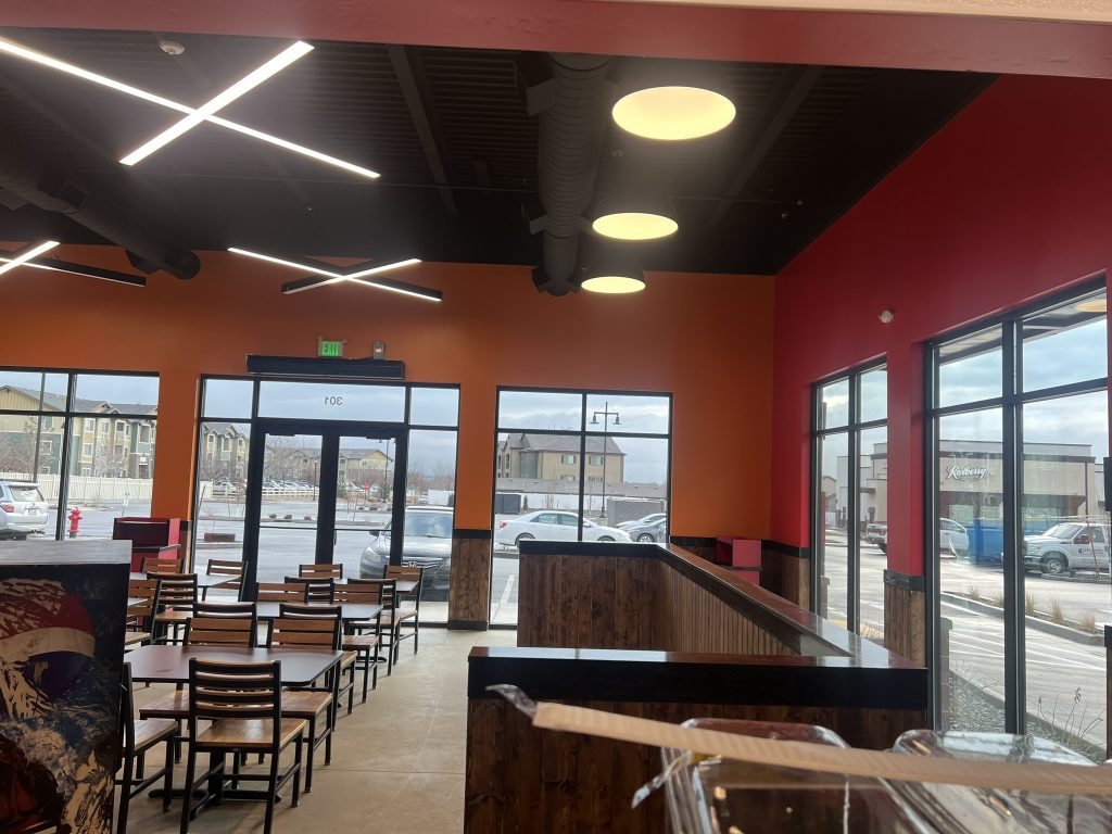 Interior view of the dining area at Don Joaquin Street Tacos, built by Black Diamond Builders, with large windows and modern lighting.