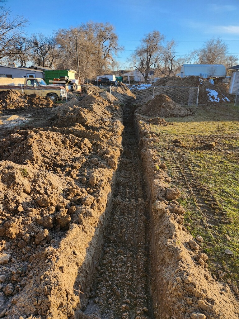 Foundation trench dug for the guest house project, preparing for concrete pouring.